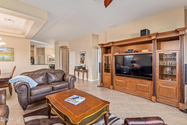 living room with light tile patterned floors and a chandelier