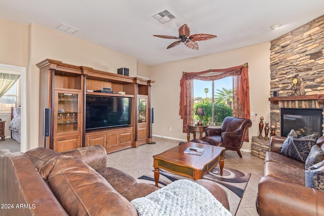 tiled living room featuring ceiling fan and a fireplace