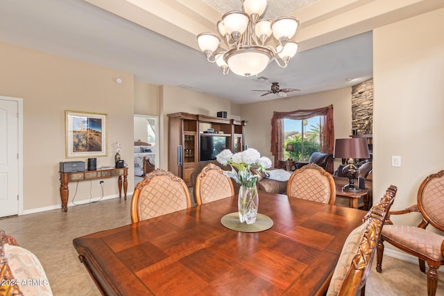 tiled dining room with ceiling fan with notable chandelier