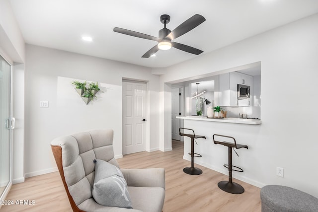 interior space with ceiling fan and light hardwood / wood-style floors