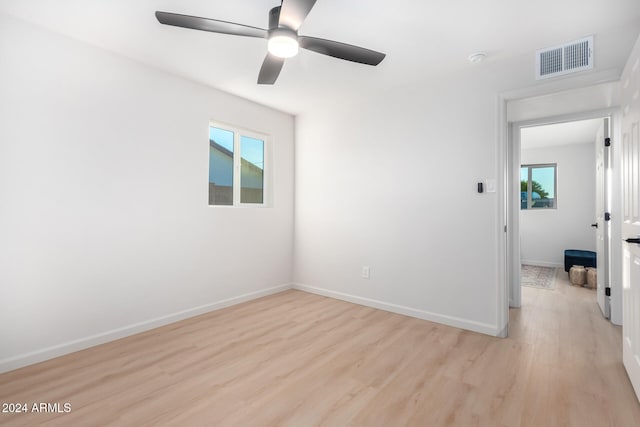 spare room with ceiling fan and light hardwood / wood-style floors