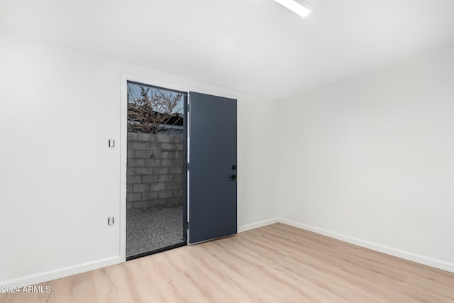 spare room with light wood-type flooring