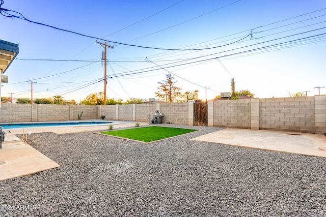 view of yard featuring a patio and a fenced in pool