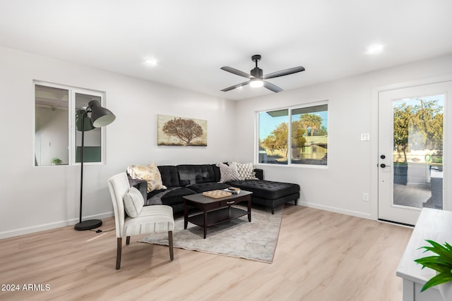 living room featuring ceiling fan and light hardwood / wood-style flooring