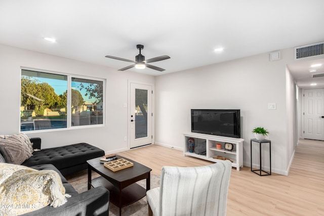 living room featuring ceiling fan and light wood-type flooring