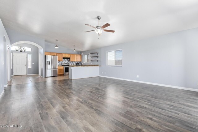 unfurnished living room with wood-type flooring and ceiling fan