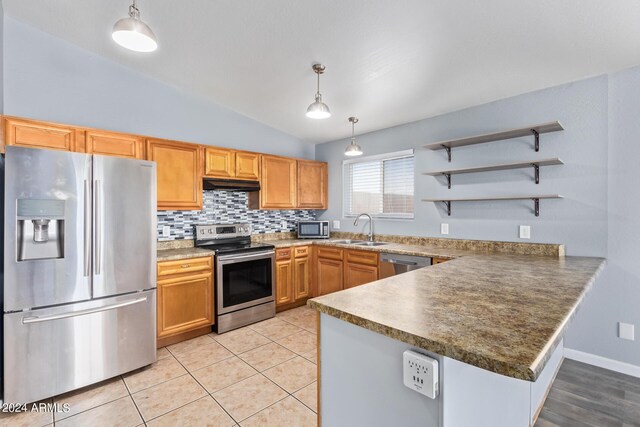 kitchen with stainless steel appliances, lofted ceiling, tasteful backsplash, and light tile patterned floors