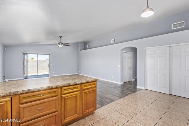 kitchen featuring light tile patterned flooring, tasteful backsplash, appliances with stainless steel finishes, decorative light fixtures, and sink