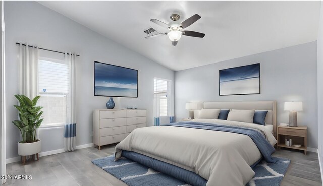 unfurnished bedroom featuring wood-type flooring, ceiling fan, a towering ceiling, and connected bathroom