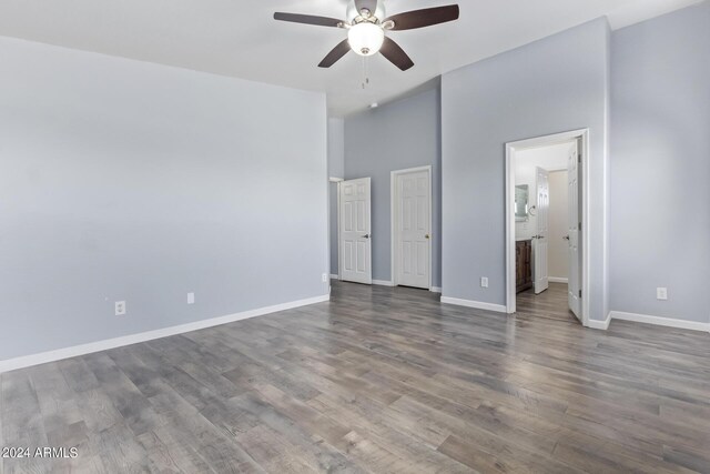 bathroom with hardwood / wood-style flooring, double sink vanity, and shower / tub combination