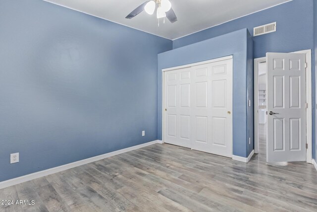 empty room with lofted ceiling, ceiling fan, and hardwood / wood-style floors