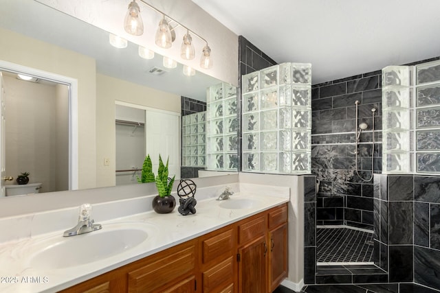 bathroom with a walk in shower and double vanity
