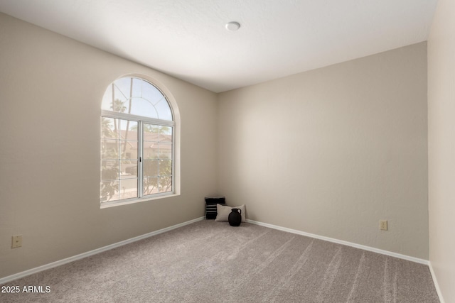 unfurnished room with plenty of natural light, carpet flooring, and baseboards