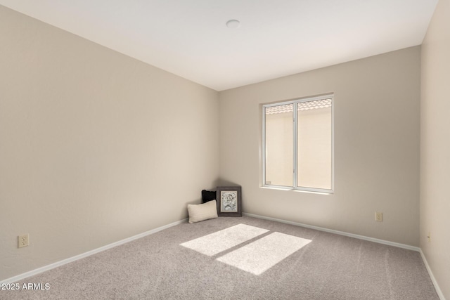 spare room with carpet flooring and baseboards