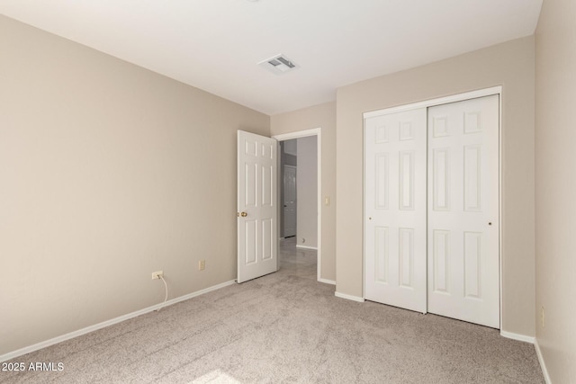 unfurnished bedroom with carpet floors, baseboards, and a closet