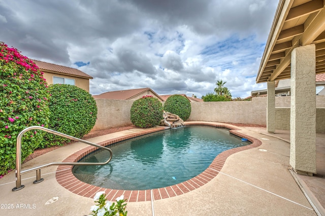 view of swimming pool with a fenced backyard and a patio area