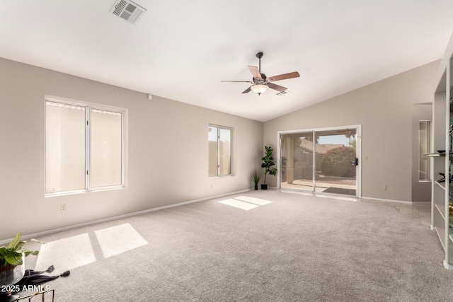 carpeted spare room with a ceiling fan, lofted ceiling, and baseboards