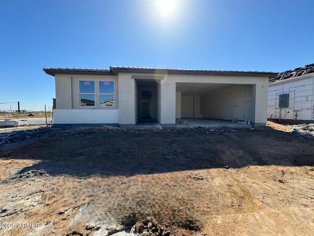 view of front of home with a patio area and stucco siding