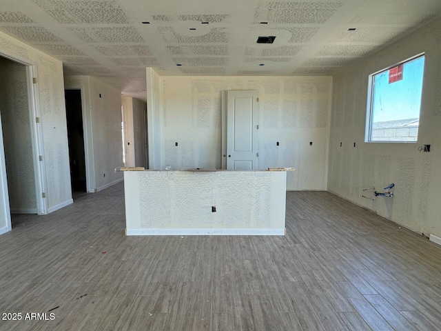 kitchen featuring open floor plan and wood finished floors