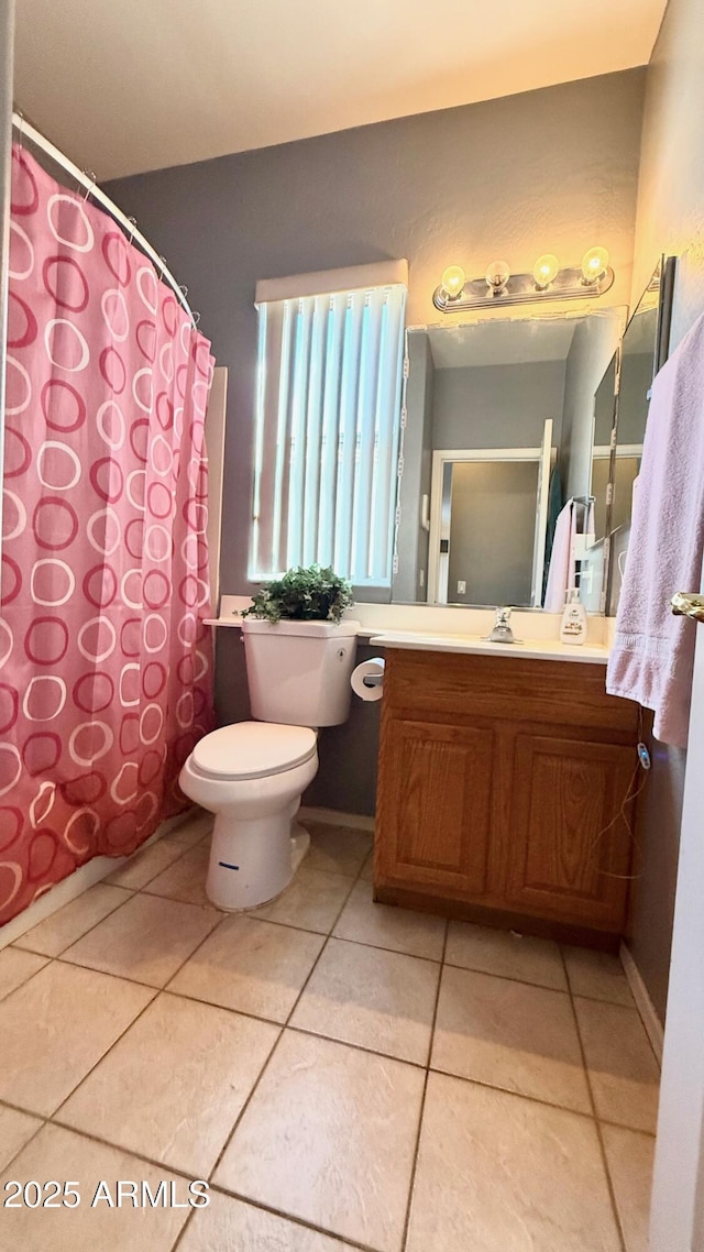 bathroom featuring tile patterned flooring, vanity, and toilet