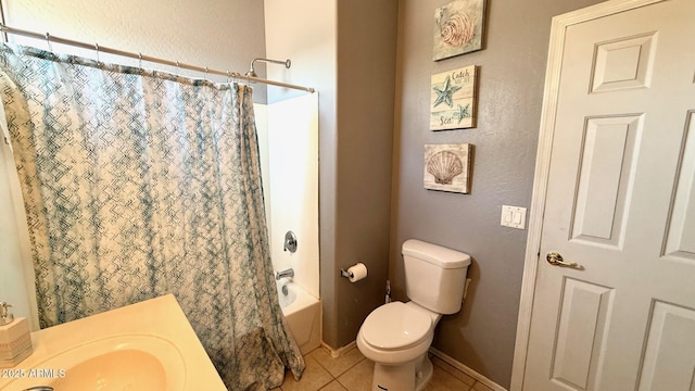 full bathroom featuring tile patterned flooring, toilet, sink, and shower / bath combo with shower curtain