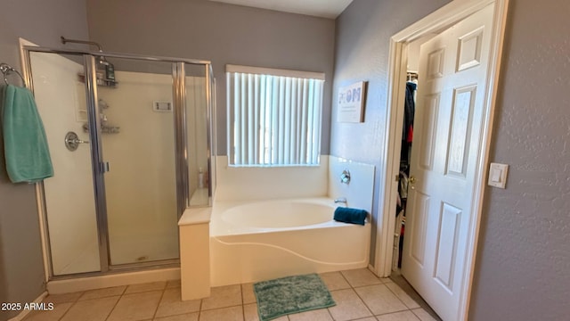 bathroom featuring tile patterned flooring and independent shower and bath