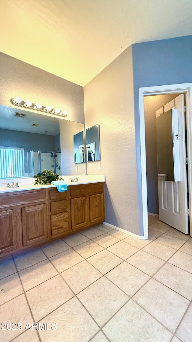 bathroom with vanity and tile patterned floors