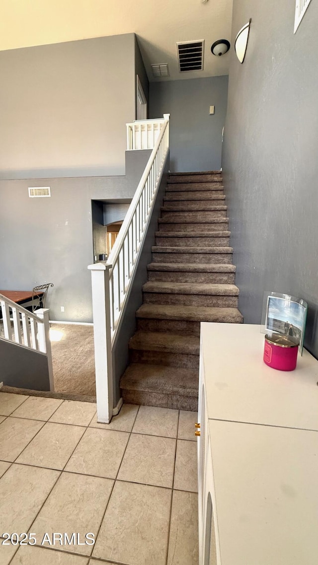 stairway featuring tile patterned floors