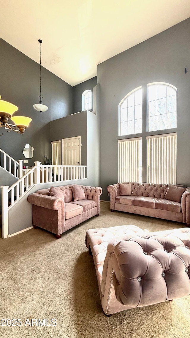 carpeted living room featuring a towering ceiling