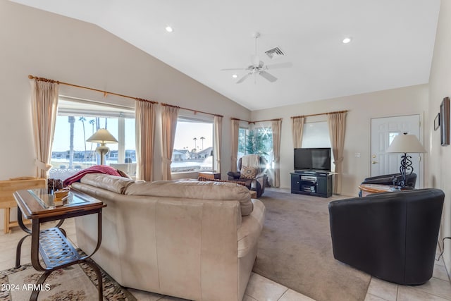 tiled living room with ceiling fan and vaulted ceiling