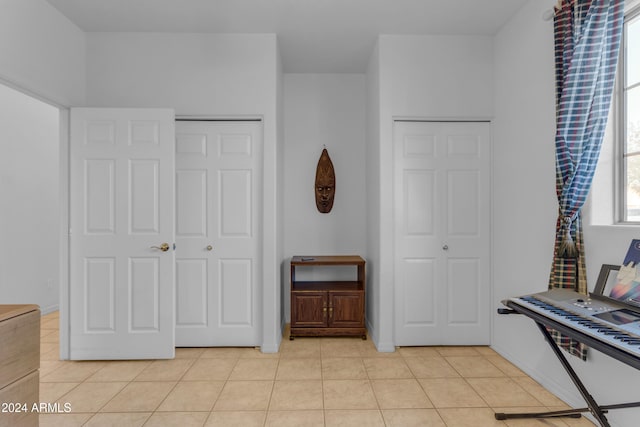 bedroom featuring light tile patterned floors and a closet