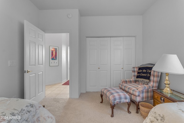 bedroom featuring light carpet and a closet