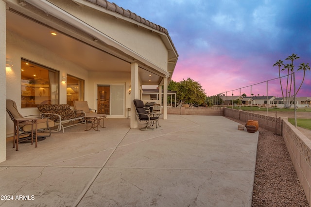 view of patio terrace at dusk