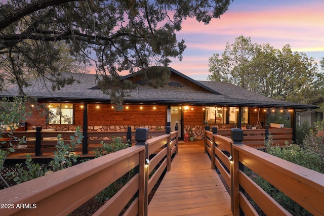 back of property featuring a shingled roof