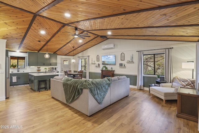 living area with a wall unit AC, light wood-style flooring, wooden ceiling, and ceiling fan