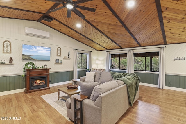 living room featuring wooden ceiling, a wall unit AC, light wood-type flooring, a ceiling fan, and wooden walls