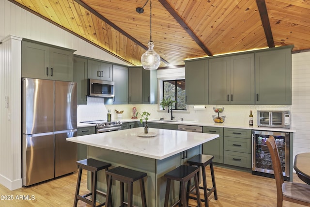 kitchen with stainless steel appliances, beverage cooler, wood ceiling, a sink, and light wood finished floors