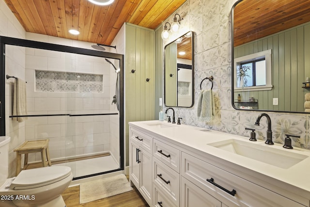 full bathroom featuring wooden ceiling, toilet, a stall shower, double vanity, and wood finished floors