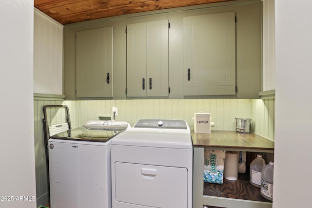 washroom featuring cabinet space, separate washer and dryer, and wood ceiling