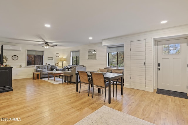 dining room featuring light wood-style flooring, ceiling fan, recessed lighting, and a wall mounted AC