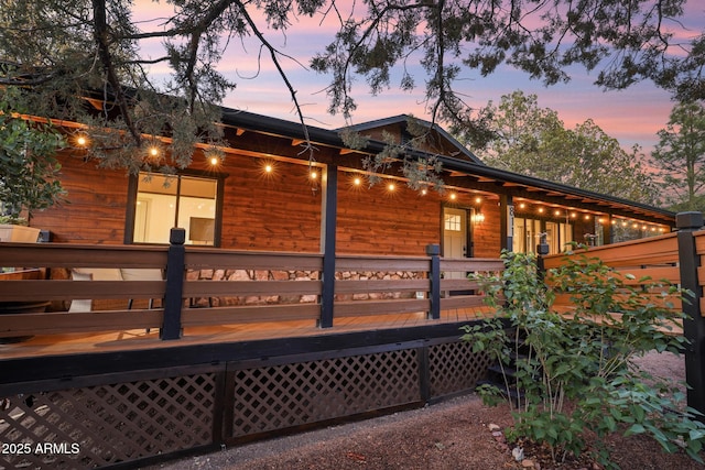view of side of home with a wooden deck