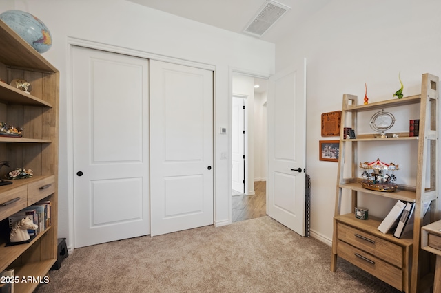 carpeted bedroom with a closet