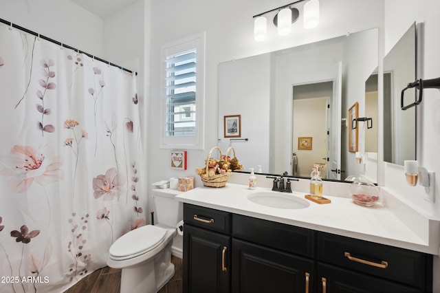 bathroom featuring a shower with curtain, vanity, and toilet