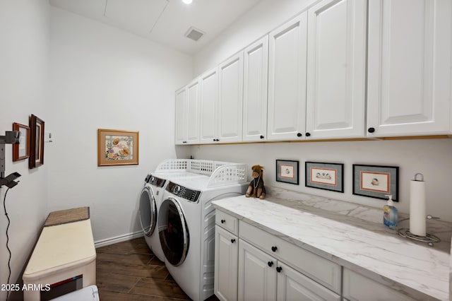 washroom featuring washer and clothes dryer and cabinets