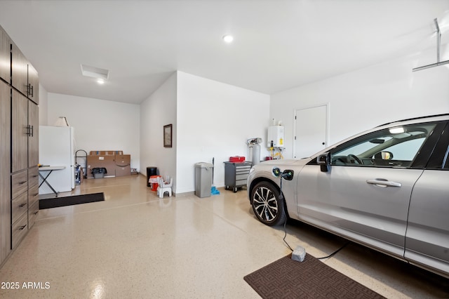 garage featuring white fridge and tankless water heater