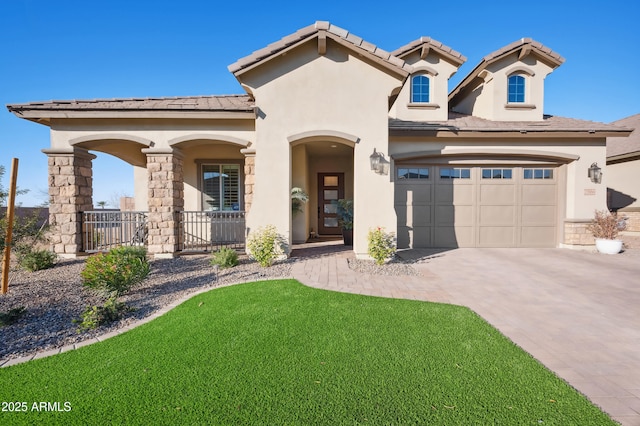 mediterranean / spanish home with a porch, a garage, and a front yard