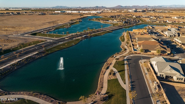 birds eye view of property with a water and mountain view