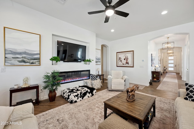 living room with hardwood / wood-style floors and ceiling fan