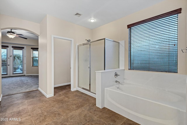 bathroom with ceiling fan and separate shower and tub