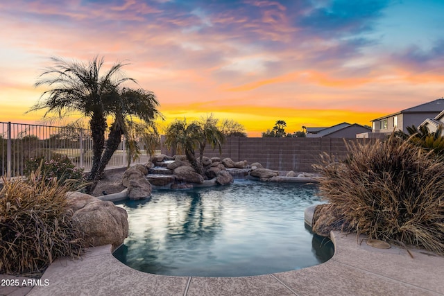 pool at dusk with pool water feature